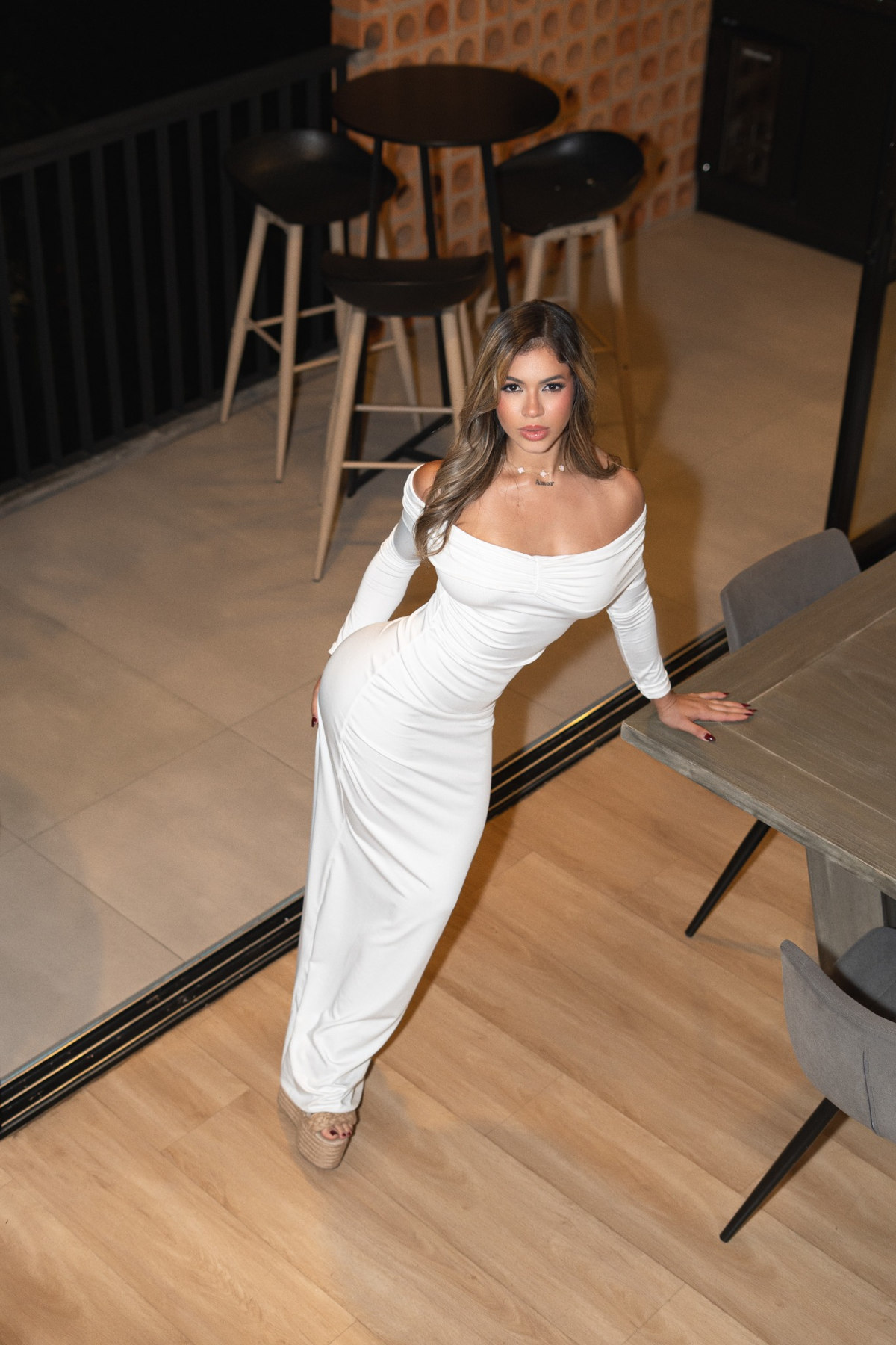 DANISAN, commercial and fashion model, wearing a white off-shoulder dress in a professional portrait